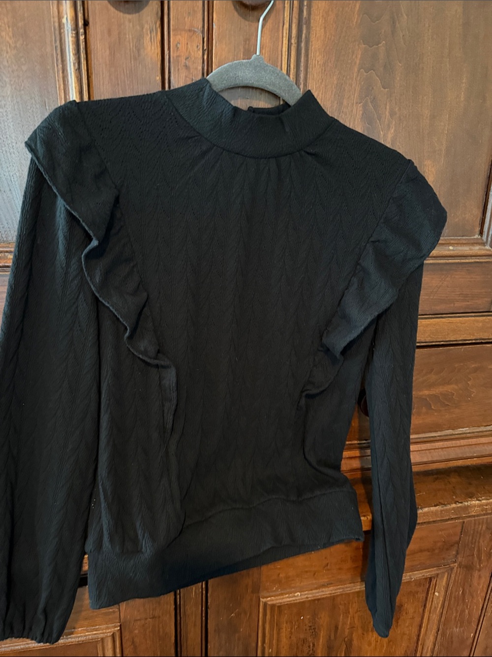 Black Ruffle-Trim Mock Neck Long Sleeve Top. Key hole and buttons on back.